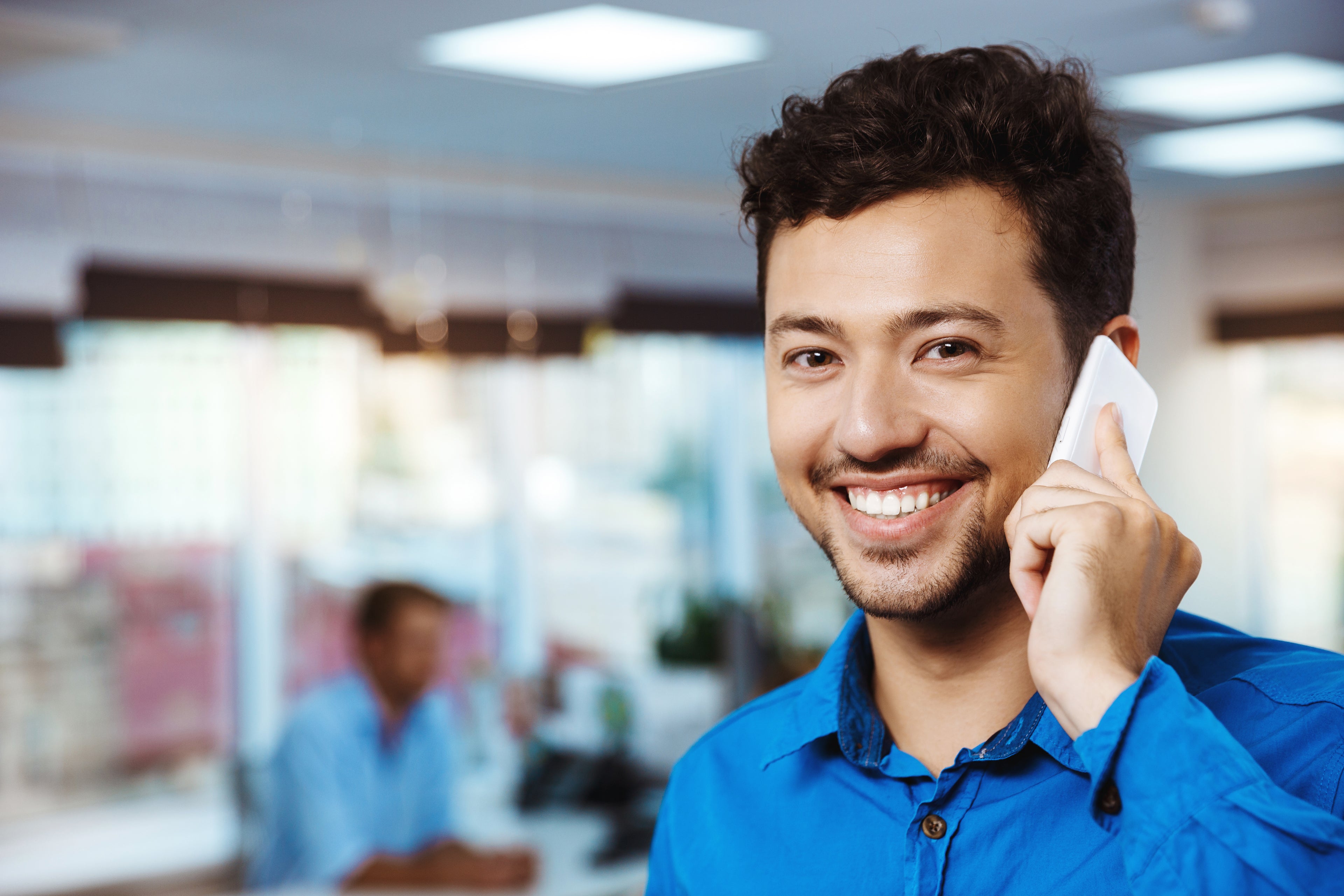 files/young-successful-businessman-speaking-phone-smiling-office.jpg